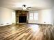 Cozy living room with a unique stone fireplace and modern flooring, perfect for relaxation at 460 Rabbit Run, Mcdonough, GA 30252