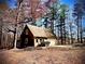 Exterior view of an outbuilding featuring a garage door, siding, and shingled roof at 460 Rabbit Run, Mcdonough, GA 30252