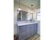 Bathroom features a gray vanity with marble countertop and modern pendant lighting at 1891 Donald Dr, Marietta, GA 30062