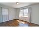 Bedroom featuring hardwood floors, neutral walls and a large window for natural light at 1891 Donald Dr, Marietta, GA 30062