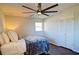 Well-lit bedroom featuring a ceiling fan, closet, and warm hardwood floors at 1891 Donald Dr, Marietta, GA 30062