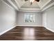 Main bedroom featuring a tray ceiling, ceiling fan, and natural light from the windows at 255 Pine Valley Dr, Powder Springs, GA 30127