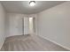 A neutral bedroom features carpet, white walls, and two doors at 5107 Madeline Pl, Stone Mountain, GA 30083