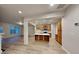 Bright, open-concept living area showcasing modern floors and seamless flow into the kitchen with island at 5107 Madeline Pl, Stone Mountain, GA 30083