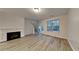 Cozy living room features a decorative fireplace, abundant natural light, and access to outdoor space at 5107 Madeline Pl, Stone Mountain, GA 30083