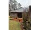 Backyard features a brick patio, lush lawn, and serene wooded views at 5207 W Shore Sw Dr, Conyers, GA 30094