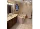 Bathroom featuring bathtub, vanity, light fixtures and tile floors at 5207 W Shore Sw Dr, Conyers, GA 30094