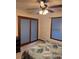 Bedroom featuring a ceiling fan, carpet, window and door with blue blinds at 5207 W Shore Sw Dr, Conyers, GA 30094