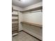 Walk-in closet with wood shelving and racks offers ample storage space at 5207 W Shore Sw Dr, Conyers, GA 30094