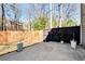 Private back patio area with a mix of wooden and black fencing creating an outdoor sanctuary at 5532 Riverside Dr, Sugar Hill, GA 30518