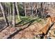 Wooded backyard with a wooden fence surrounding the property at 5532 Riverside Dr, Sugar Hill, GA 30518