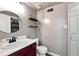 Small bathroom featuring a round mirror, wood shelves, gray paint, and a white toilet at 5532 Riverside Dr, Sugar Hill, GA 30518