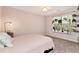 Serene bedroom with pink walls, soft carpet, and natural light at 5532 Riverside Dr, Sugar Hill, GA 30518