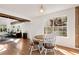 Bright dining area with hardwood floors, a round wood table, and sunlit windows at 5532 Riverside Dr, Sugar Hill, GA 30518