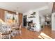 Dining area features hardwood floors, chandelier and natural light at 5532 Riverside Dr, Sugar Hill, GA 30518