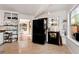 Light-filled kitchen featuring a black refrigerator, white cabinets, and hardwood floors at 5532 Riverside Dr, Sugar Hill, GA 30518