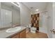 Bathroom featuring a single sink vanity, tub-shower combo and wood floors at 573 Rendezvous Rd, Acworth, GA 30102