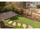 Backyard features a stone paver patio, artificial lawn with stone steps and wood perimeter fence at 10528 Serenbe Ln, Chattahoochee Hills, GA 30268