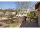Multi-level deck overlooking an enclosed backyard with mature trees and lawn at 10528 Serenbe Ln, Chattahoochee Hills, GA 30268