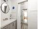 Bright bathroom featuring neutral paint, stylish fixtures, a glass-enclosed shower, and updated tile flooring at 10528 Serenbe Ln, Chattahoochee Hills, GA 30268