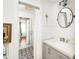 Bright bathroom featuring a glass shower, modern fixtures, and stylish patterned floor tiles at 10528 Serenbe Ln, Chattahoochee Hills, GA 30268