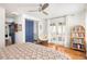 Bright bedroom with hardwood floors, ceiling fan, and access to balcony through french doors at 10528 Serenbe Ln, Chattahoochee Hills, GA 30268