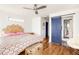 Bedroom features hardwood floors, a sliding barn door to the bathroom and decorative headboard at 10528 Serenbe Ln, Chattahoochee Hills, GA 30268