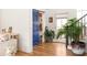 Stylish entryway featuring hardwood floors, blue accent door, and a decorative potted plant at 10528 Serenbe Ln, Chattahoochee Hills, GA 30268