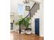 Bright foyer showcasing hardwood floors, staircase, and potted plant adding a touch of nature at 10528 Serenbe Ln, Chattahoochee Hills, GA 30268