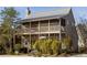 Charming two-story home with a screened-in porch on each level and lush landscaping at 10528 Serenbe Ln, Chattahoochee Hills, GA 30268
