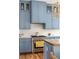 Updated kitchen featuring stainless steel appliances, blue cabinets, and stylish countertops at 10528 Serenbe Ln, Chattahoochee Hills, GA 30268