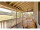 Screened porch with daybed overlooking a tranquil yard with mature trees at 10528 Serenbe Ln, Chattahoochee Hills, GA 30268