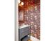 Charming powder room featuring colorful wallpaper, a vanity with storage, and an ornate mirror at 10528 Serenbe Ln, Chattahoochee Hills, GA 30268