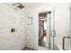 Tiled walk-in shower with glass door and bronze hardware in a bright, modern bathroom at 10528 Serenbe Ln, Chattahoochee Hills, GA 30268