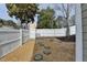 The backyard features a white fence, rock ground covering, and mature trees at 1284 Warsaw Rd, Roswell, GA 30076