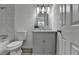 Bathroom showcasing a marble vanity, sleek toilet, and tiled tub and shower at 1284 Warsaw Rd, Roswell, GA 30076