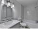 Bathroom featuring white-tiled walls, modern fixtures, and marble countertops at 1284 Warsaw Rd, Roswell, GA 30076