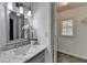Updated bathroom with marble countertops, a decorative mirror and a window to let in plenty of light at 1284 Warsaw Rd, Roswell, GA 30076