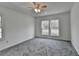 Bedroom filled with natural light and featuring neutral carpeting and a ceiling fan at 1284 Warsaw Rd, Roswell, GA 30076