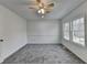 Bright bedroom with a ceiling fan, carpeted floor, and windows bringing in natural light at 1284 Warsaw Rd, Roswell, GA 30076