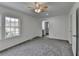 Bedroom featuring neutral carpet, white walls and trim, plus a bright window and open door at 1284 Warsaw Rd, Roswell, GA 30076