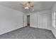 Bedroom with neutral carpet, white trim, a closet, and ample light from the exterior window at 1284 Warsaw Rd, Roswell, GA 30076