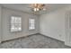 Bedroom featuring neutral carpet, bright windows, and white trim at 1284 Warsaw Rd, Roswell, GA 30076