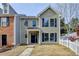 Charming two-story home with a well-manicured lawn and inviting front porch and attractive architectural details at 1284 Warsaw Rd, Roswell, GA 30076