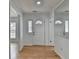 Bright foyer featuring hardwood floors, white walls, and a front door with decorative window and transom at 1284 Warsaw Rd, Roswell, GA 30076