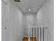 Hallway with white walls, and staircase with wood floors and a decorative accent wall at 1284 Warsaw Rd, Roswell, GA 30076