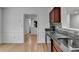 Bright kitchen featuring hardwood floors and granite countertops with tile backsplash and an open view to other rooms at 1284 Warsaw Rd, Roswell, GA 30076