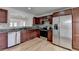 Well-lit kitchen with stainless steel appliances, granite countertops, and wooden cabinets offering ample storage at 1284 Warsaw Rd, Roswell, GA 30076