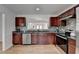 Well-lit kitchen with stainless steel appliances, granite countertops, and wooden cabinets offering ample storage at 1284 Warsaw Rd, Roswell, GA 30076