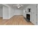 Open living room featuring a fireplace, windows, and hardwood flooring at 1284 Warsaw Rd, Roswell, GA 30076
